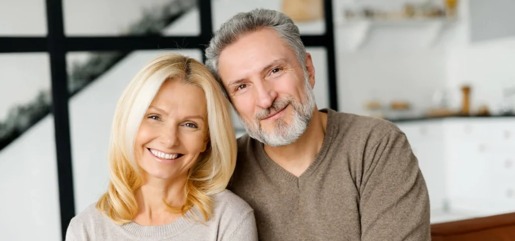 Smiling middle-aged couple at home, looking healthy and relaxed