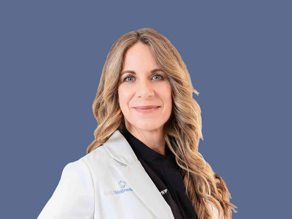 Erika of Loop Wellness Clinic in a white coat, smiling