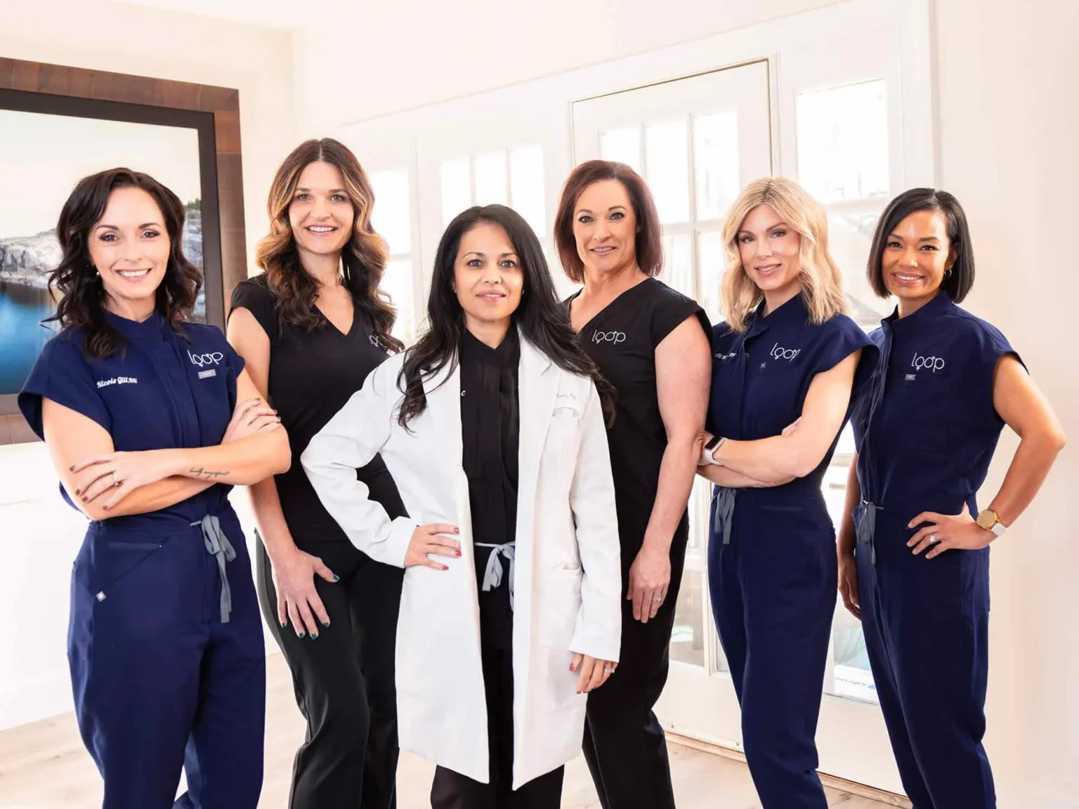 The Loop Wellness Clinic care team standing together in navy and white Loop uniforms